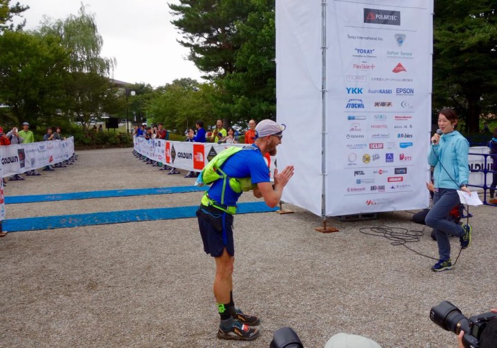 Working on my Japanese bow to the crowd at the finish. Photo by Meghan Hicks/iRunFar