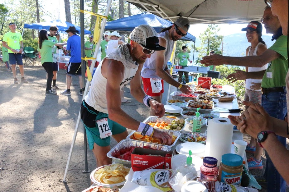 Grabbing some quick calories at Duncan Canyon aid station. Photo by Miriam Simon Carter